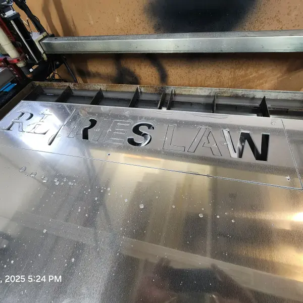Prcess of laser cutting where sheet metal is in the process of being cut